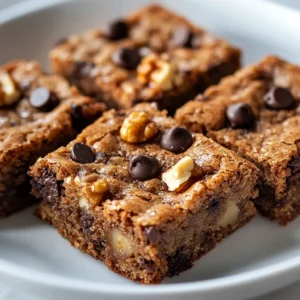 Banana bread blondies are a delightful twist on the classic banana bread, merging rich, sweet flavors of ripe bananas with a chewy and buttery blondie texture. Each bite offers a burst of moistness and sweetness, making them an ideal treat for any time of the day—be it an afternoon snack, a satisfying dessert after dinner, or a delightful addition to a potluck. The use of simple pantry ingredients ensures that these blondies are quick to whip up, allowing you to indulge in their warm, comforting embrace in virtually no time.