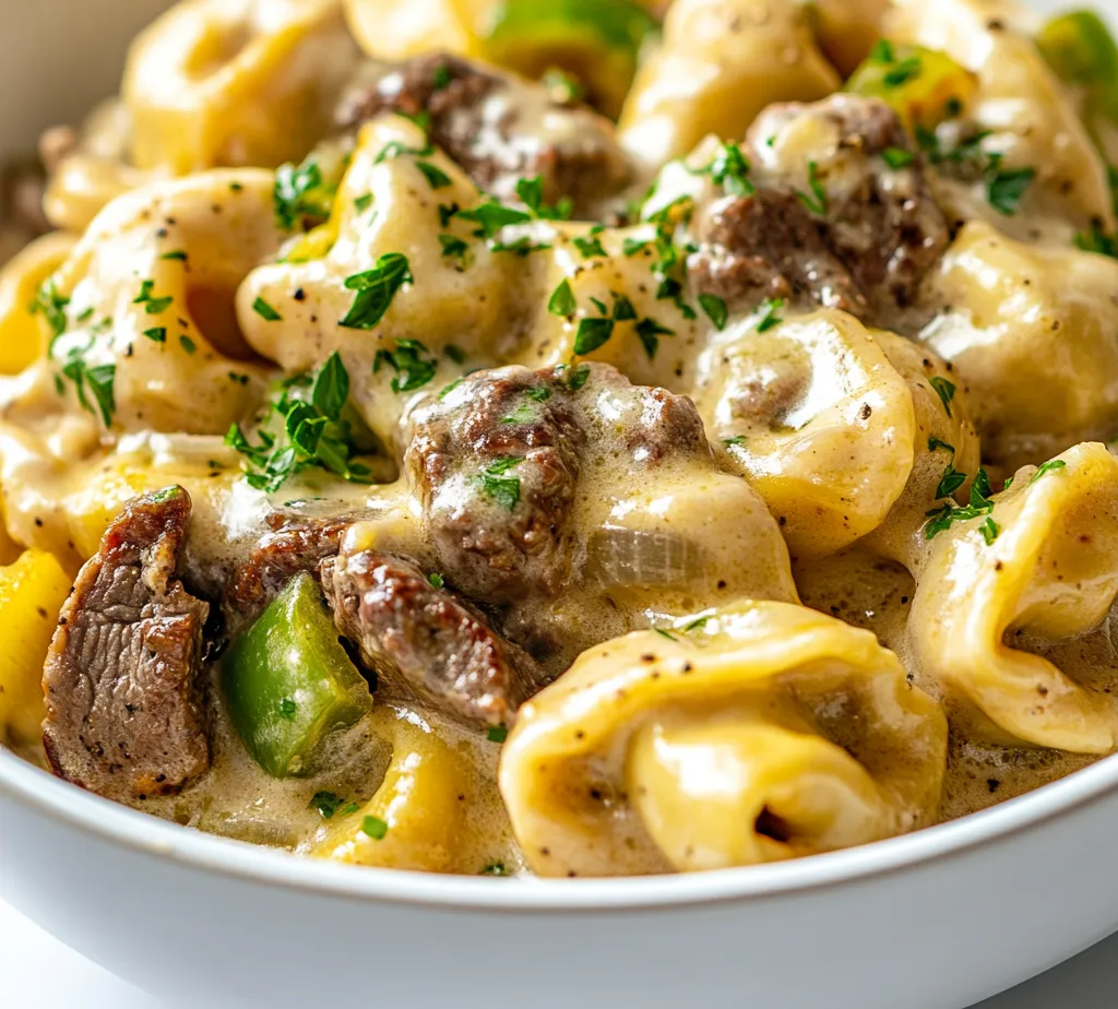 The blend of flavors in the cheesesteak tortellini with creamy provolone sauce offers a delightful culinary experience that combines classic Italian pasta with quintessential American flavors. The rich, savory elements of tender beef sirloin, sautéed onions, and green bell peppers enveloped in a luscious provolone cheese sauce create an exquisite dish that is luxurious yet accessible. Perfect for a comforting weeknight dinner, this recipe allows you to indulge in the beloved components of a traditional cheesesteak in a unique pasta form.