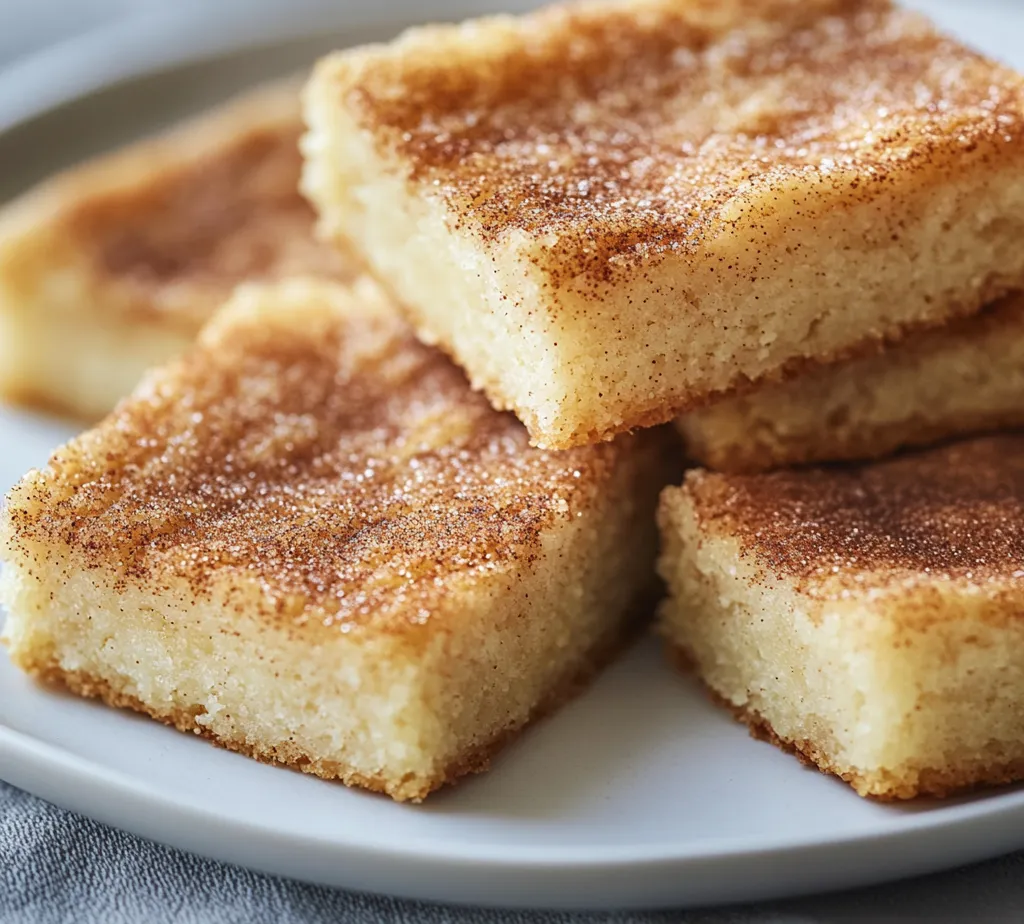 Crafting desserts that capture the essence of home and nostalgia can be immensely rewarding, and nothing embodies this sentiment quite like snickerdoodle bars. These soft, chewy delights are a beloved treat, marrying the warm spices of cinnamon with a sweet, buttery base. Unlike traditional cookies, these bars deliver the same comforting flavors in an easy-to-make format that’s perfect for sharing and enjoying with loved ones. Every bite of a snickerdoodle bar promises an experience of sweetness, spice, and warmth that transports you back to cozy gatherings and cherished memories.