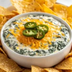 Exploring the world of dips, the Zesty Spinach Ranch Dip stands out as a deliciously creamy and tangy option that beckons any snack lover. This American appetizer, packed with wholesome ingredients, offers a perfect blend of flavors that can elevate any gathering or casual get-together. Whether you’re looking for a quick snack to enjoy during a movie night or an impressive addition to a party platter, this dip promises to delight your taste buds.