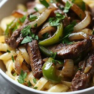 The Philly cheesesteak is an iconic sandwich that hails from the streets of Philadelphia. Known for its tender ribeye steak, melty cheese, and sautéed onions, this beloved dish has evolved over time into various delightful interpretations. One such version takes the traditional flavors of this classic sandwich and transforms them into a creamy, comforting pasta dish: the Philly Cheesesteak Pasta Delight. This dish skillfully combines the savory essence of a cheesesteak with the satisfying texture of penne pasta, making it an excellent option for busy weeknight dinners or for impressing guests at a casual gathering.