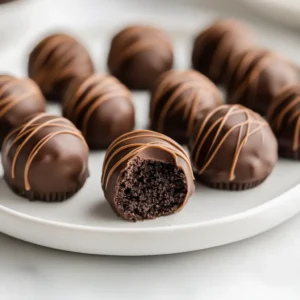 The delightful blend of peanut butter, cream cheese, and Oreos creates a symphony of flavors in the Peanut Butter Oreo Delight Truffles, a treat that is as pleasing to the palate as it is visually enticing. These truffles boast a creamy core wrapped in a rich chocolate shell that makes them an irresistible option for dessert enthusiasts of all ages. They are perfect for a variety of occasions, be it a festive gathering, an elegant dinner party, or a cozy night in spent with family.