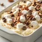 The Mississippi Mud Mashed Potato Casserole is a unique dish that embodies the comforting essence of American cooking, seamlessly blending hearty ingredients that deliver both savory and sweet flavors. This delightful casserole takes the traditional comfort of mashed potatoes and elevates it with layers of melted sharp cheddar cheese, creamy sour cream, and a perfect finishing touch of mini marshmallows and chocolate chips. The result is a dish that can effortlessly steal the spotlight at family gatherings or holiday feasts.